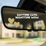 Daytime look of heart stickers on a car mirror, cute minimal car decor.