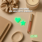 Glow in the dark heart and star stickers in an aesthetic flat lay for planners, desks, and accessories.