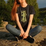 Woman wearing glow in the dark astronaut shirt outdoors, perfect for camping, hiking, and stargazing.