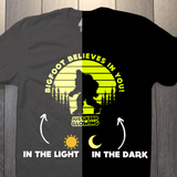 Bigfoot glow in the dark shirt shown in daylight and glowing at night comparison
