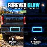 Seafoam blue license plate frame installed on a black pickup truck in daylight, compared with its blue glow at night.