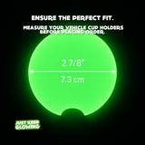 Glowing green cup holder coaster with measurements on a black background