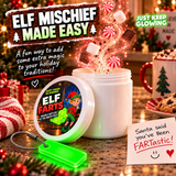 Funny Christmas elf prank idea featuring an open Elf Farts scented jar, glowing green keychain, magical fragrance and a handwritten Santa note on a festive kitchen counter.