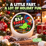 Elf Farts limited holiday scent jar with a festive elf label displayed among snowy Christmas greenery, wrapped presents, ornaments and candy with a holiday gift headline.