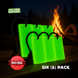 Six-pack of Forever Glow Bars, reusable glow in the dark camping lights with black paracord loops, glowing green beside a campfire.
