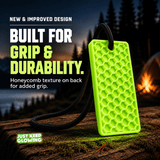 Close view of the Forever Glow Bar honeycomb textured back with black paracord, showing the improved grip design at a nighttime campsite.