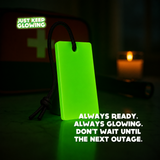 Reusable Forever Glow Bar glowing green beside an emergency first aid kit and candle, illustrating its use during power outages.