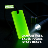 Forever Glow Bar reusable glow in the dark light being charged with a flashlight for battery-free camping and emergency use.