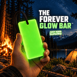 Forever Glow Bar reusable green glow in the dark bar held at a mountain campsite with a campfire, lake and tent at night.
