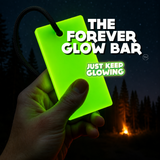 Forever Glow Bar reusable glow in the dark stick held in hand at a nighttime campsite, providing battery-free visibility.