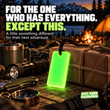 Forever Glow Bar displayed beside a wrapped gift, flashlight, compass and camping equipment as a practical gift idea for outdoor enthusiasts.