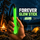 Forever Glow Stick glowing green in a hand at a mountain campsite, showing a reusable glow in the dark stick with black paracord for camping and outdoor adventures.