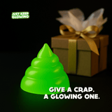 Glow in the dark poop toy next to wrapped gift, funny gag gift and stocking stuffer idea.