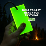Hand holding glow bar in the dark near campsite – durable glow in the dark travel light.