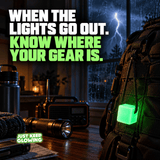 Green Mini Glow Cube attached to an emergency backpack beside a flashlight and weather radio during a nighttime thunderstorm.