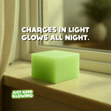 Glow Cube XL charging on a windowsill in sunlight, reusable glow cube that glows all night after exposure to light.