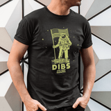 Man wearing glow in the dark astronaut T-shirt with patriotic flag design, outdoor adventure style.