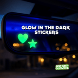 Glow in the dark heart and star stickers on a car mirror, cute car accessories for women.