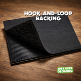 Close-up view of the hook-and-loop backing on a glow-in-the-dark American flag morale patch, showing secure Velcro-style attachment.