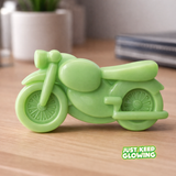 Glow-in-the-dark motorcycle toy shown in daylight, green rechargeable glow toy for kids and gifts