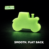 Back view of glow-in-the-dark tractor with smooth flat back, thick solid resin design that glows for hours