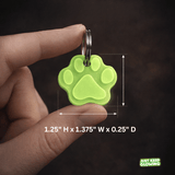 Small glow in the dark pet tag size shown in hand, lightweight dog and cat collar tag for everyday use and night visibility