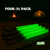 Four (4) pack of reusable green glow sticks with paracord loops on a wooden table.
