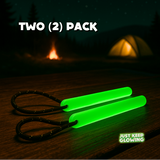 Two (2) pack of reusable green glow sticks with paracord loops on a wooden table.
