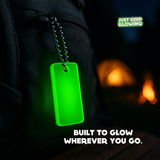 Glow tag on backpack at campsite – glow in the dark travel accessory for backpacks and gear.