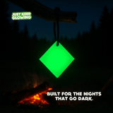 Glow Tile glowing by campfire – reusable glow in the dark light for camping and emergency kits
