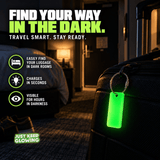Reusable green Forever Glow Tag hanging from a suitcase in a dark hotel room, illustrating battery free luggage identification and travel gear marking after the lights go out.