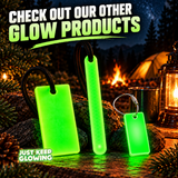 Just Keep Glowing collection of reusable green glow in the dark products, including a Forever Glow Bar, Forever Glow Stick and keychain tag at a nighttime campsite.