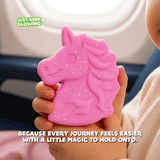 Child holding unicorn comfort toy on airplane — perfect travel-friendly glow companion for kids