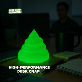 Glow in the dark poop desk toy on office desk, funny coworker gift and rechargeable novelty light.