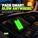 Reusable green Forever Glow Bar resting inside an open suitcase with clothing, headphones, and passport, illustrating lightweight travel preparedness for hotels, cruises, and vacations.
