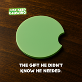 Glow in the dark green car coaster with crescent notch on wood table – handmade Just Keep Glowing™ vehicle cup holder insert, perfect unique gift for men.